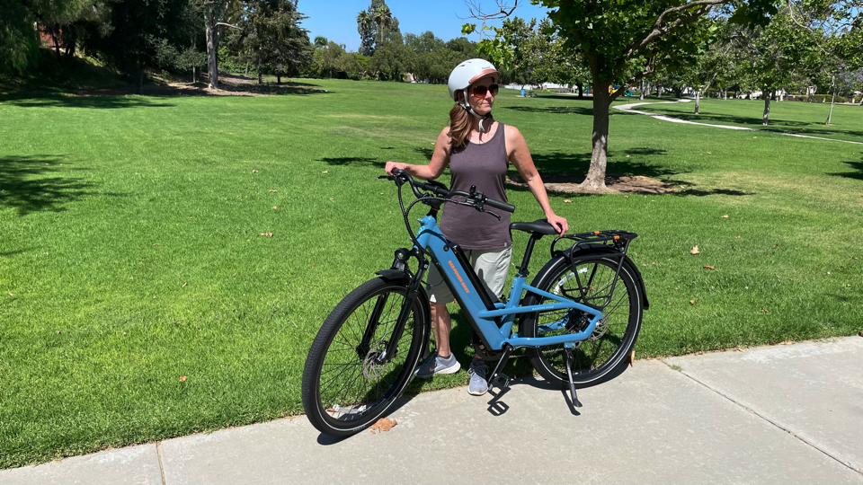 woman standing next to Rad Power Bikes Radster Road