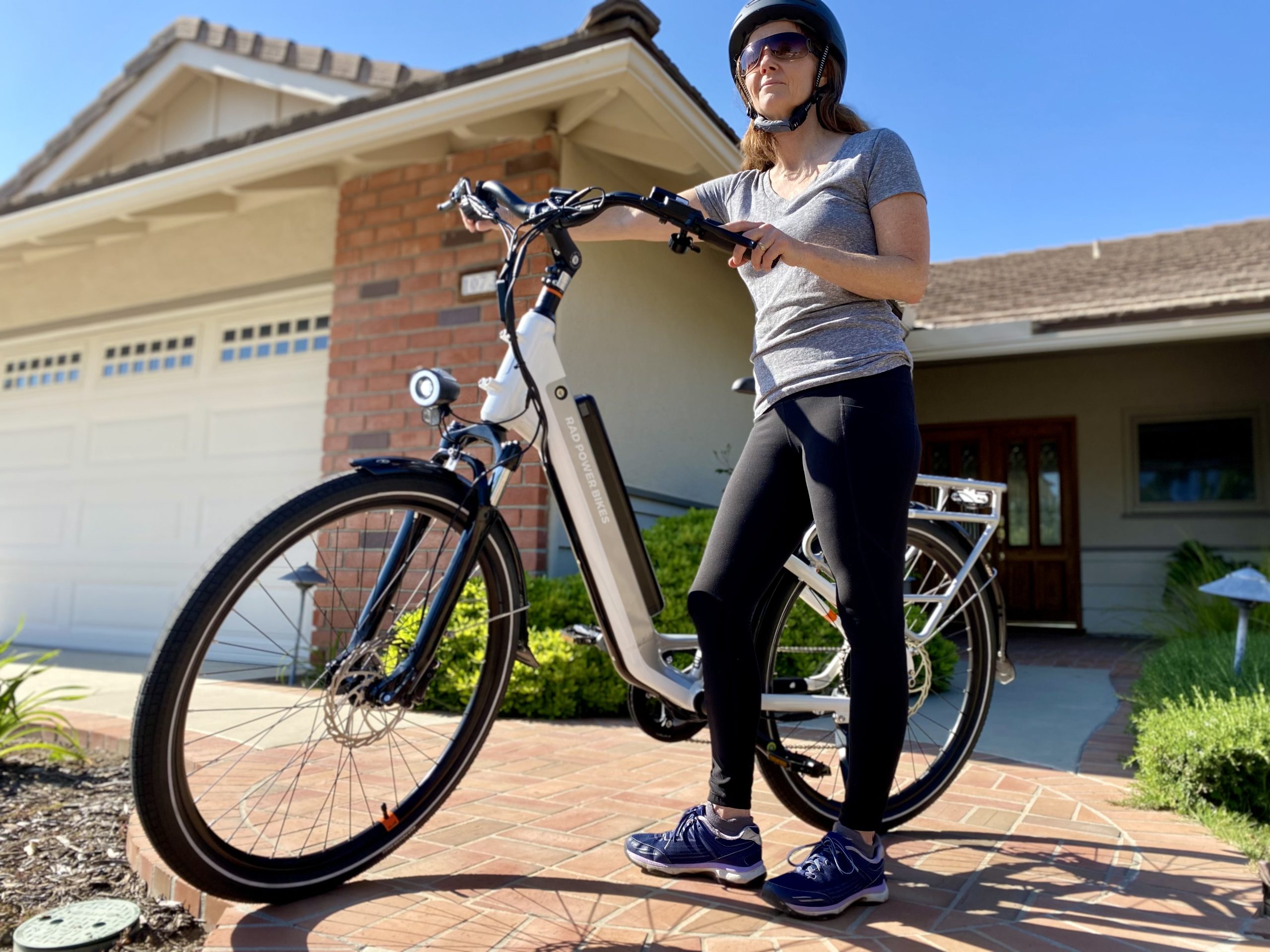 Women with bike helmet on standing next to RadCity E-Bike