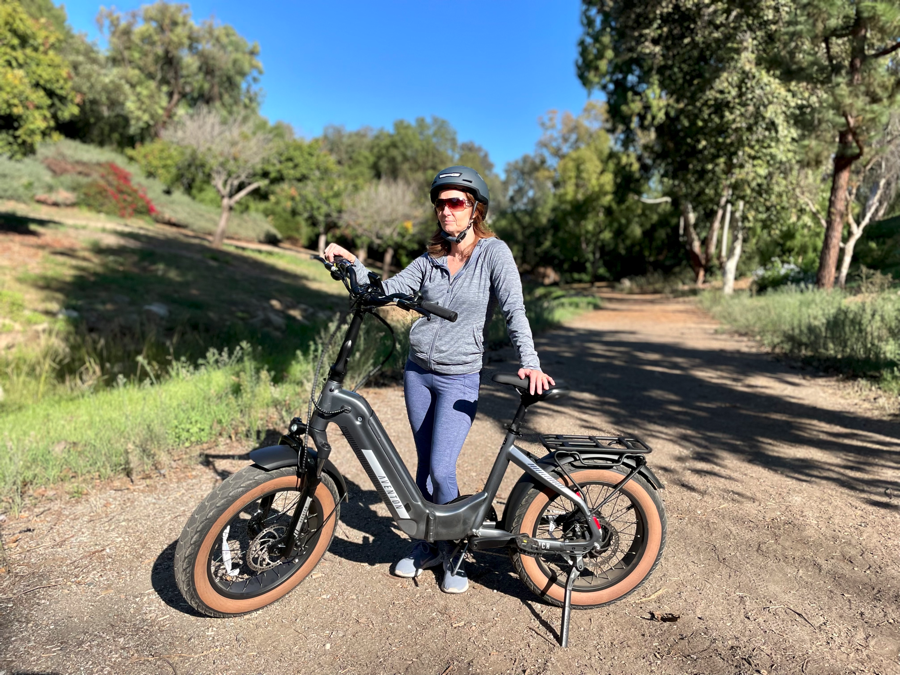 Woman standing next to Aventon Sinch.2 Electric Bike