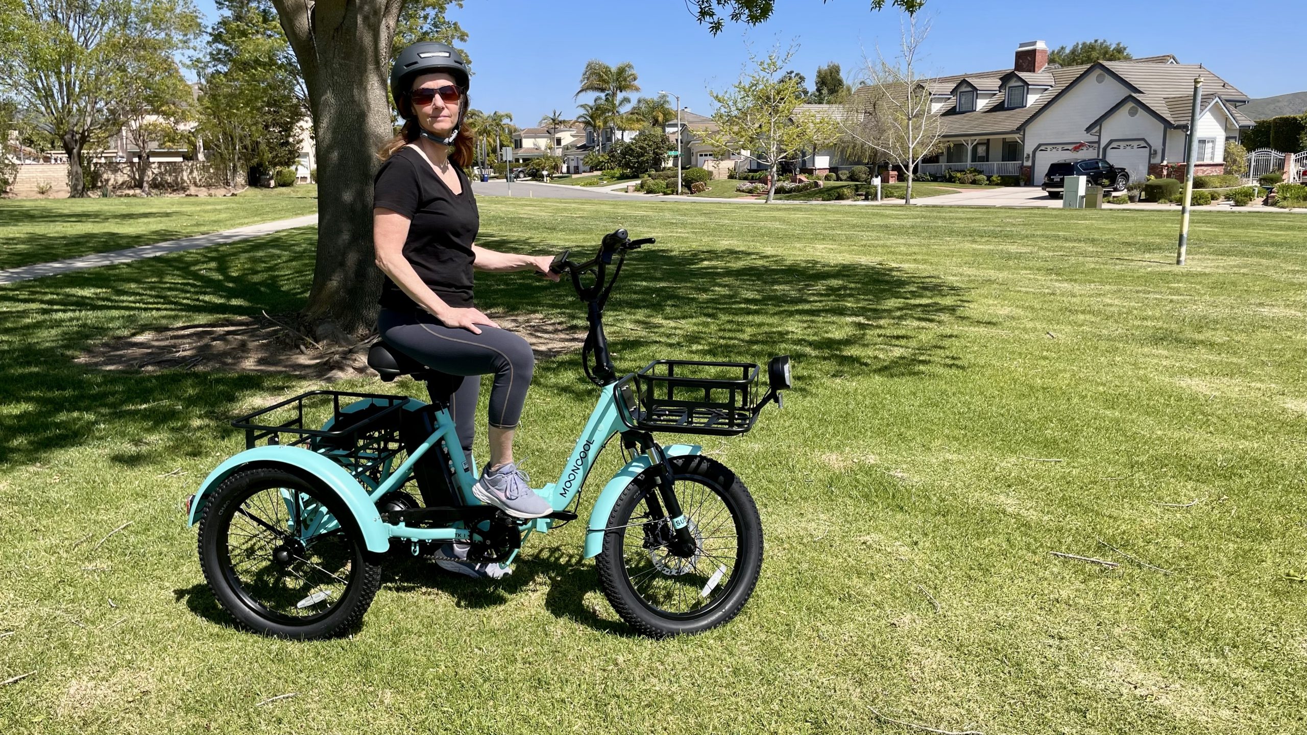 Woman sitting on electric folding trike