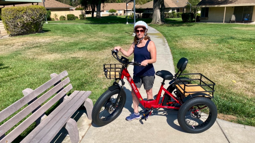 Woman standing next to the Emojo Bison Pro electric trike