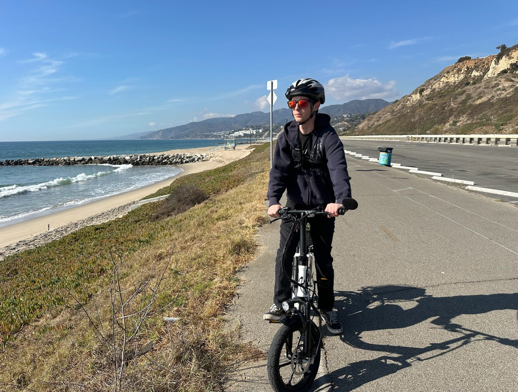 Young adult riding a white Hoverfly electric bike