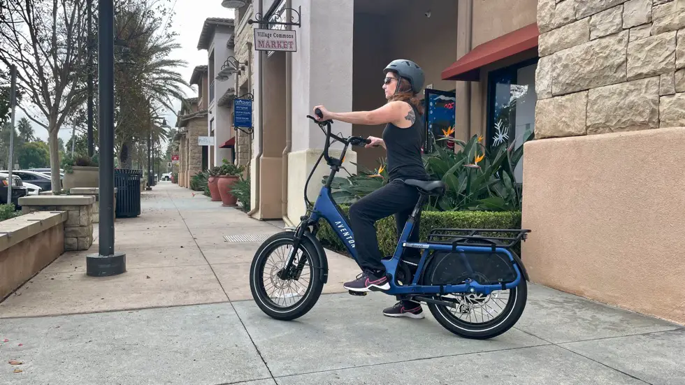 Woman sitting on Aventon Abound SR Cargo E-Bike